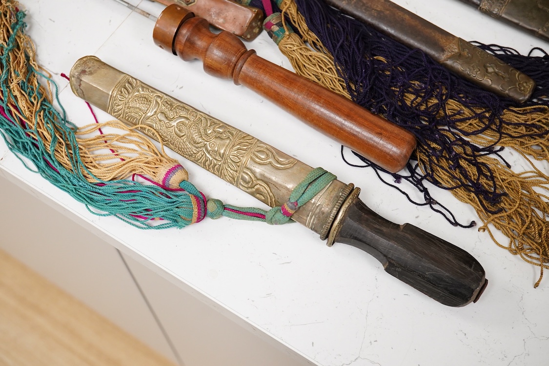 Four Tibetan daggers, early 20th century and a prayer wheel